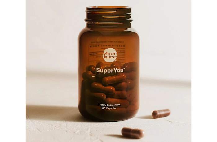 An amber-colored glass bottle of Moon Juice SuperYou